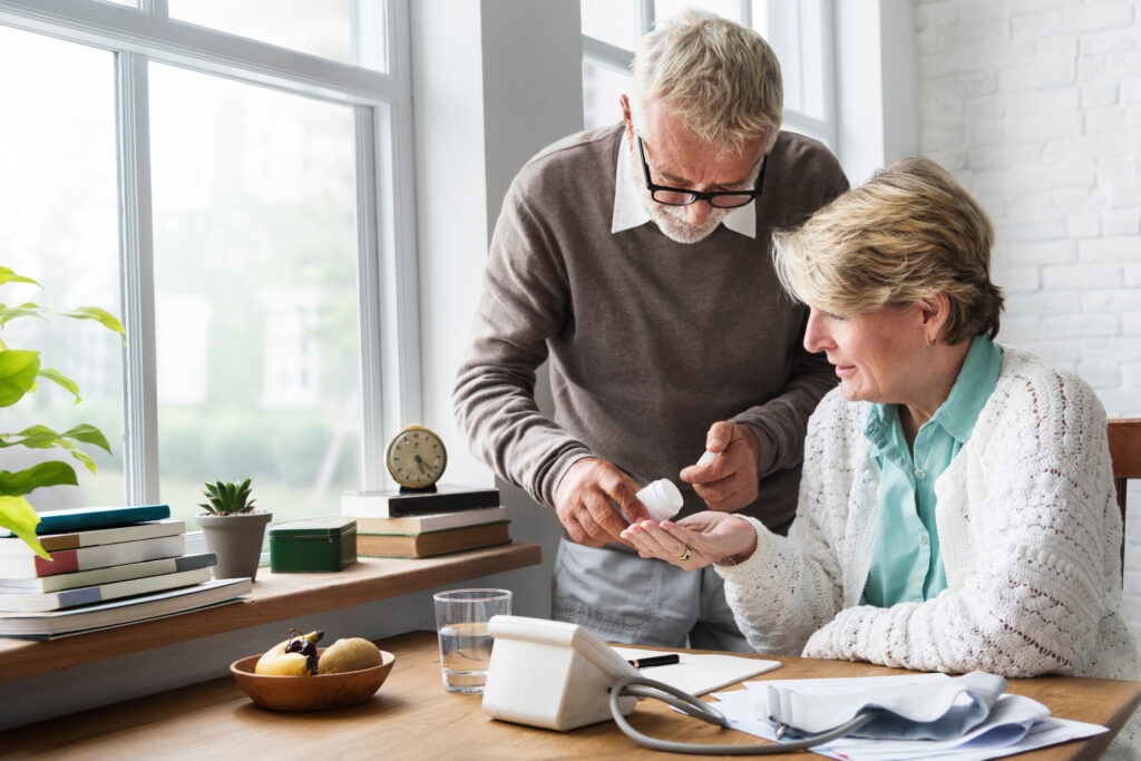 Older adults taking pills at home