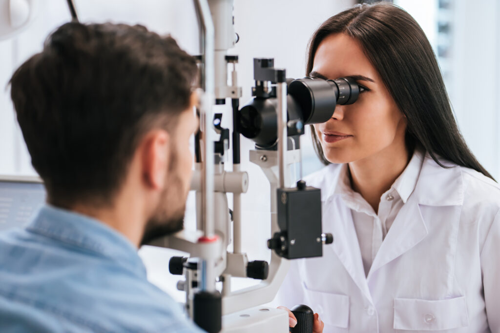 Man receiving an eye exam in a clinic.