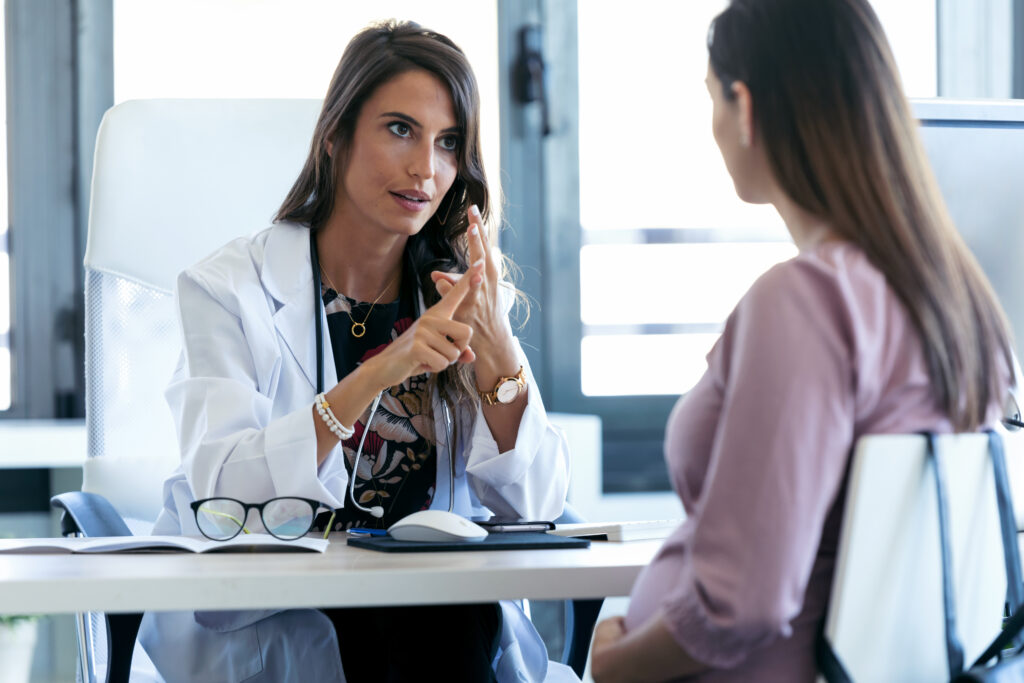 Woman talking to a patient in a medical clinic