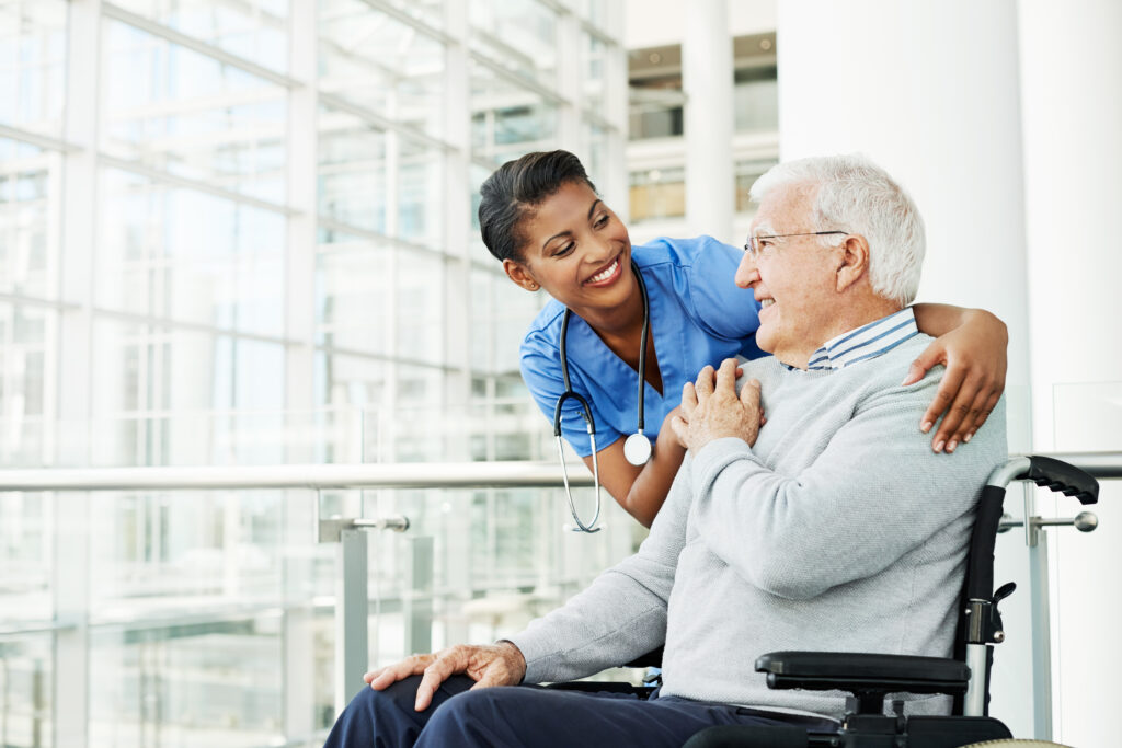 Shot of a young nurse caring for an elderly patient in a wheelchair