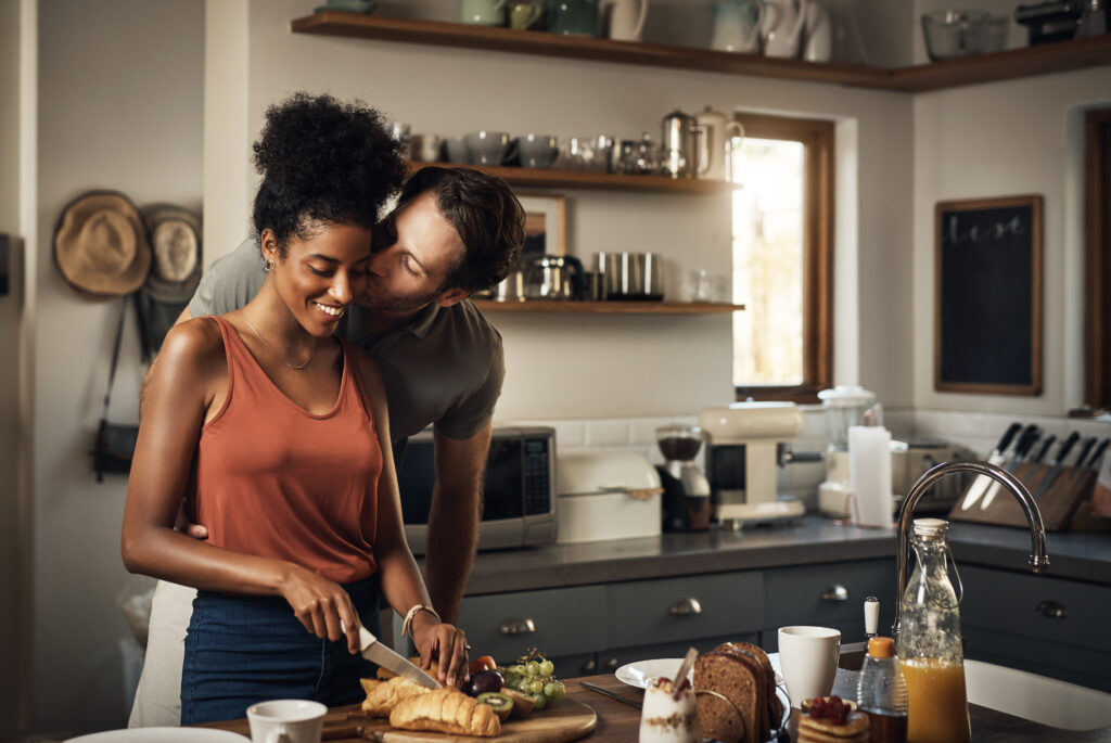 Couple making breakfast together in the kitchen